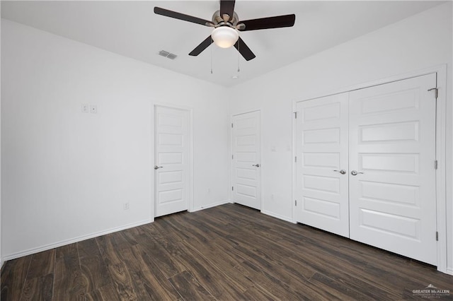 unfurnished bedroom with dark hardwood / wood-style flooring and ceiling fan