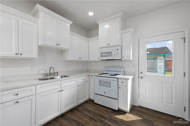 kitchen with sink, white cabinets, and white appliances