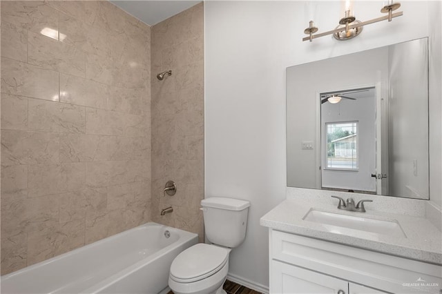 full bathroom with tiled shower / bath combo, toilet, and vanity