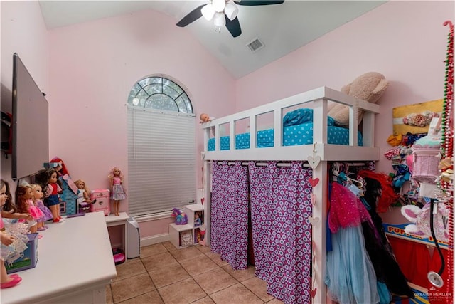 tiled bedroom featuring ceiling fan and vaulted ceiling