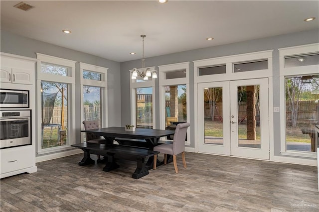 dining room featuring french doors, dark hardwood / wood-style floors, and a notable chandelier