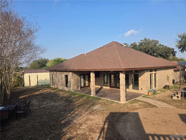 back of house featuring a patio area and a storage shed