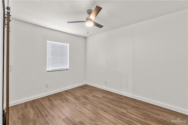 1018 N Keralum Ave, Mission, TX 78572 - spare room featuring wood finished floors, ceiling fan, and baseboards