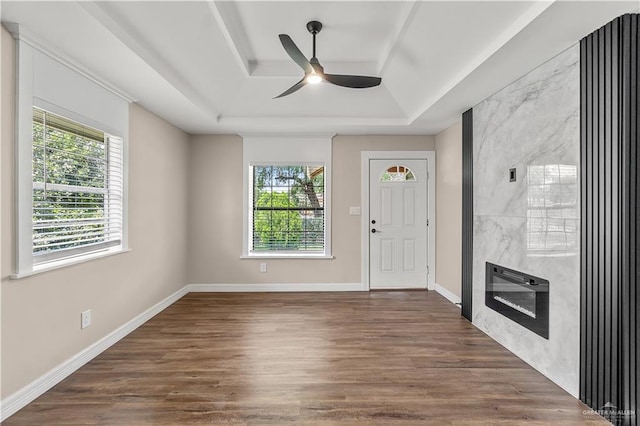 1018 N Keralum Ave, Mission, TX 78572 - entryway featuring a tray ceiling, a ceiling fan, a high end fireplace, and wood finished floors