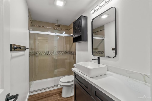 1018 N Keralum Ave, Mission, TX 78572 - bathroom with a shower stall, toilet, wood finished floors, and vanity