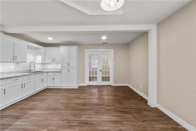 1018 N Keralum Ave, Mission, TX 78572 - kitchen featuring a sink, white cabinetry, decorative backsplash, dark wood-type flooring, and recessed lighting