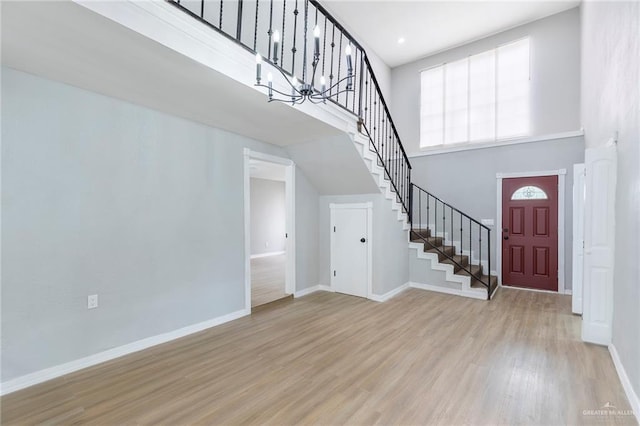 7201 S San Marcos St, Pharr, TX 78577 - entryway featuring stairs, light wood finished floors, baseboards, a towering ceiling, and a chandelier