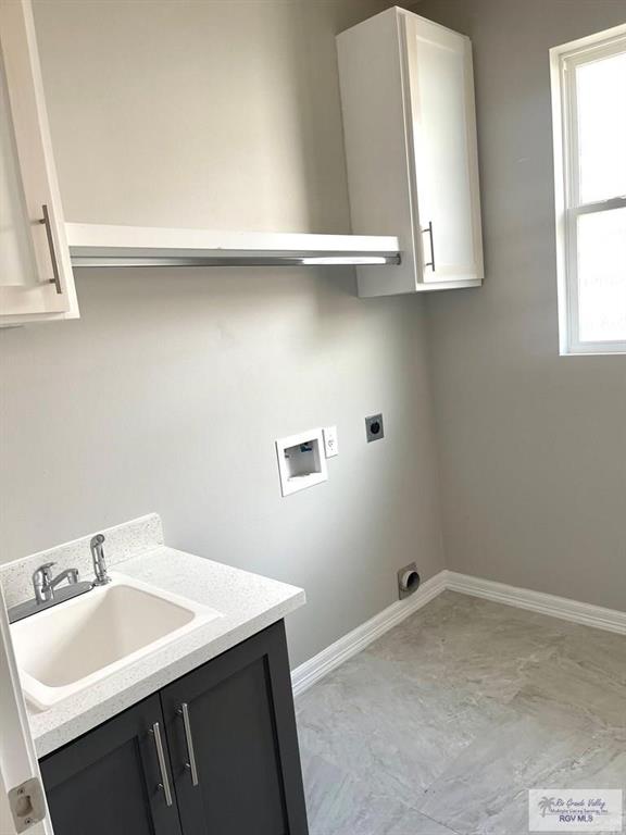 laundry area with a sink, hookup for a washing machine, baseboards, and hookup for an electric dryer