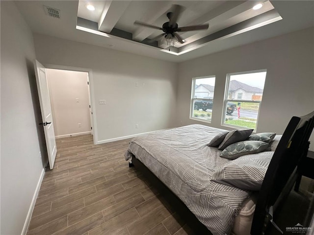 bedroom featuring a tray ceiling and ceiling fan