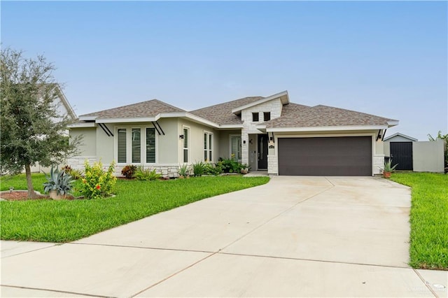 view of front of property with a garage and a front lawn