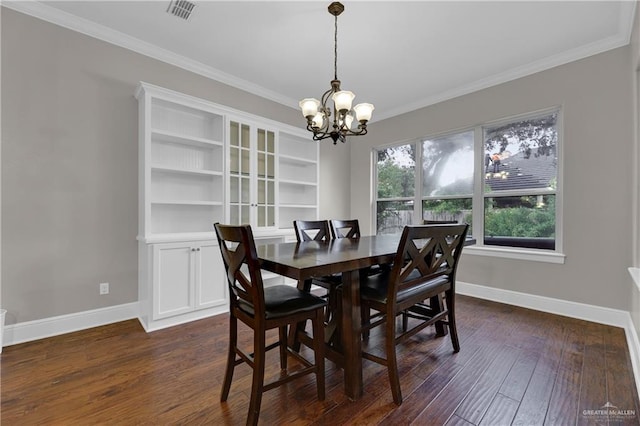 dining room featuring dark hardwood / wood-style flooring, crown molding, and an inviting chandelier