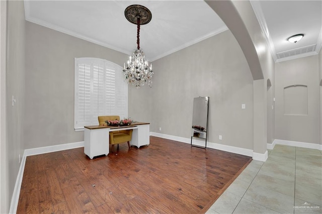 dining space with an inviting chandelier, ornamental molding, and light hardwood / wood-style flooring