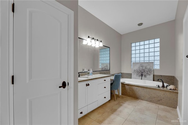 bathroom featuring vanity, tile patterned floors, and tiled bath