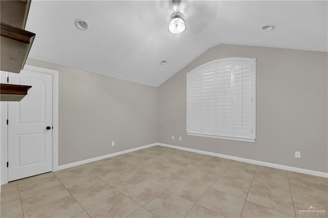 bonus room featuring light tile patterned flooring and vaulted ceiling