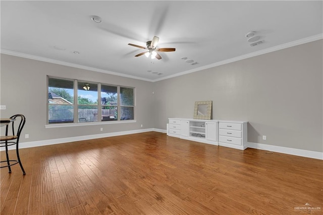 empty room with wood-type flooring, ornamental molding, and ceiling fan