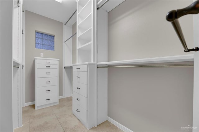 spacious closet with light tile patterned floors