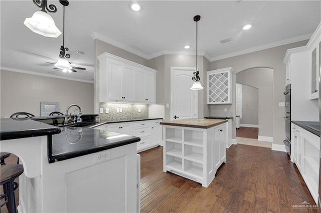 kitchen featuring sink, white cabinets, and kitchen peninsula