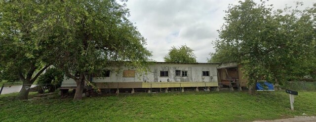 rear view of property with a yard