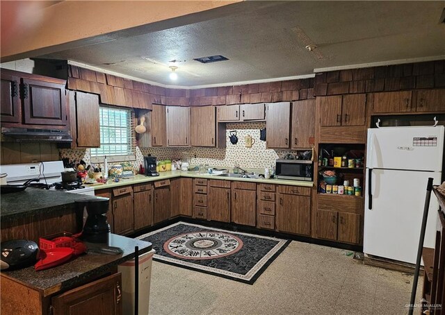 kitchen with white appliances, extractor fan, dark brown cabinetry, and sink