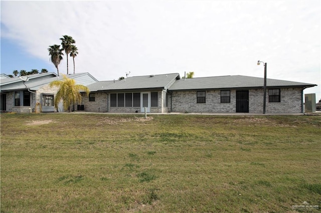 rear view of house featuring a yard