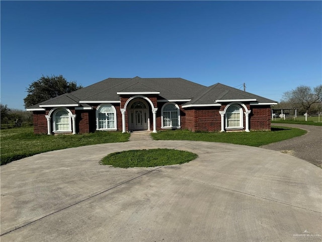 ranch-style home with a front lawn