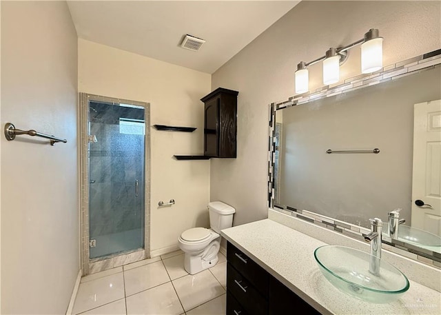 314 N 17th St, Hidalgo, TX 78557 - full bathroom featuring a stall shower, toilet, vanity, tile patterned flooring, and baseboards