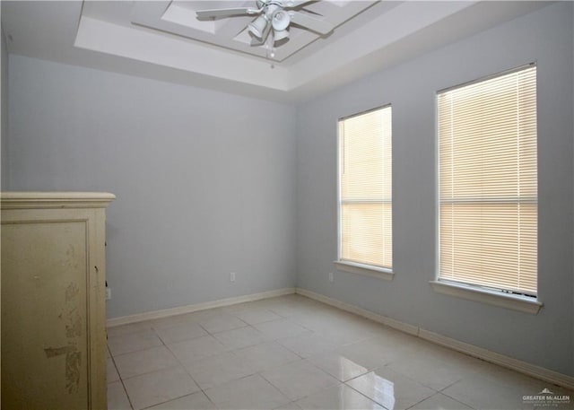 314 N 17th St, Hidalgo, TX 78557 - unfurnished room with a tray ceiling, ceiling fan, light tile patterned floors, and healthy amount of natural light