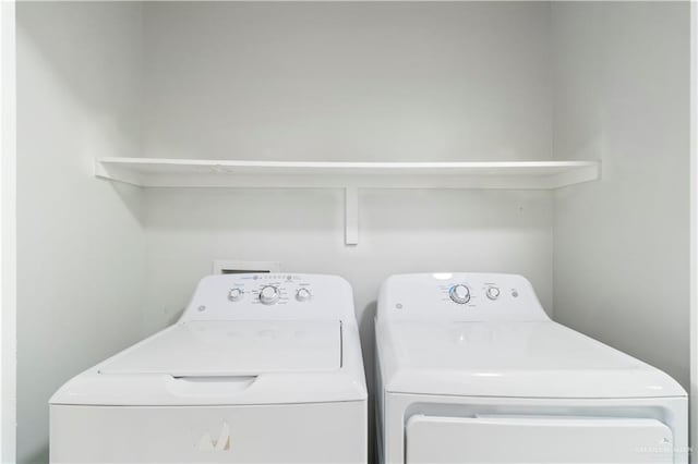 clothes washing area with laundry area and washer and clothes dryer