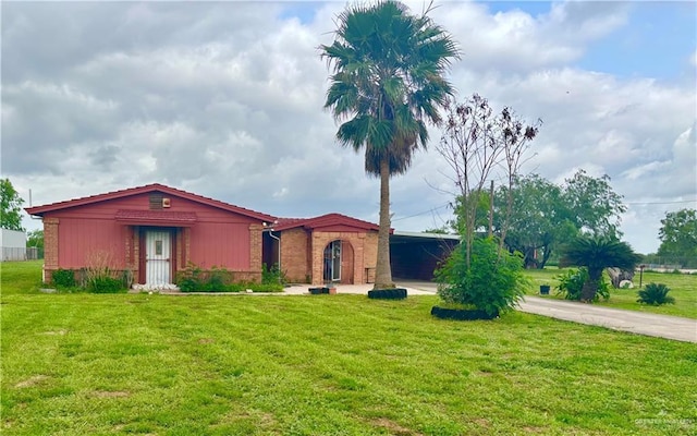31665 US Highway 281, Edinburg, TX 78542 - view of front of home featuring brick siding, a front yard, and concrete driveway
