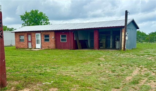 31665 US Highway 281, Edinburg, TX 78542 - back of property featuring a lawn, fence, and metal roof