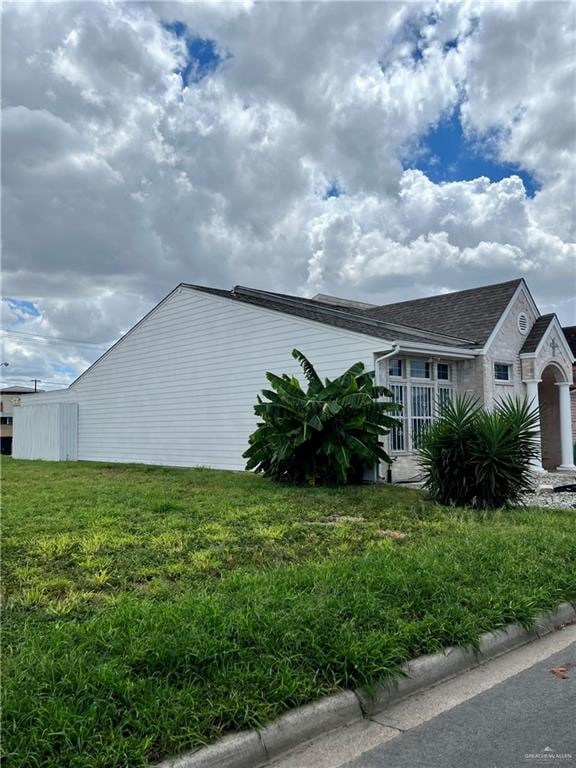 view of property exterior with a lawn