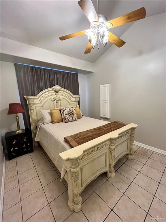 bedroom with ceiling fan, light tile patterned floors, and lofted ceiling