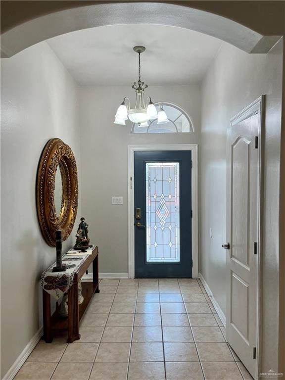 entrance foyer featuring light tile patterned flooring and a chandelier