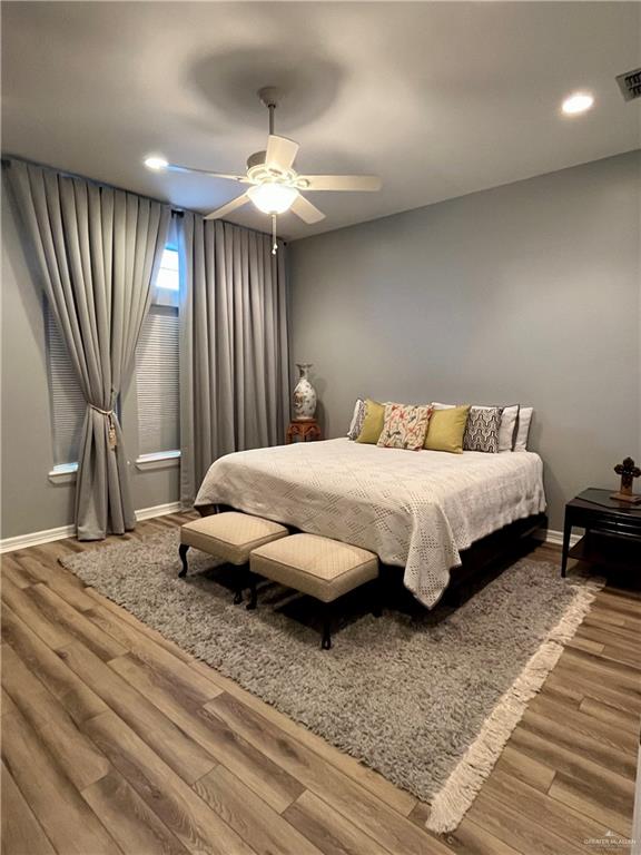 bedroom with ceiling fan and hardwood / wood-style floors