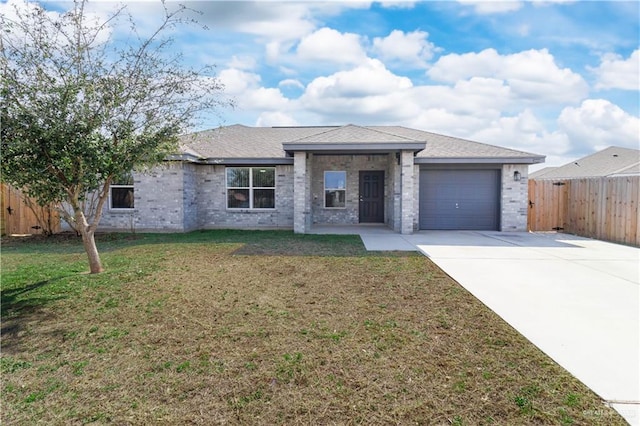 view of front of home with a garage and a front lawn