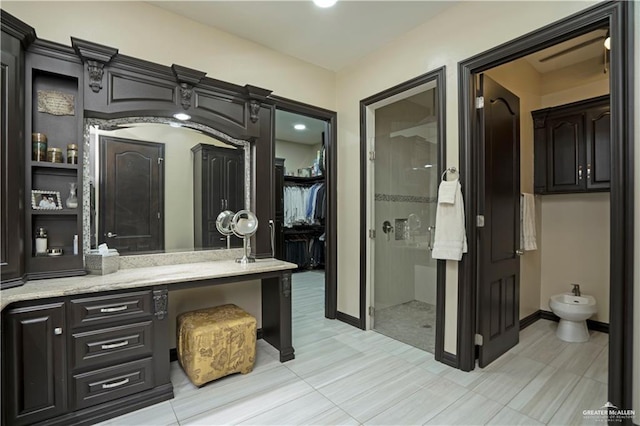 bathroom featuring tile patterned flooring, vanity, a shower, and a bidet