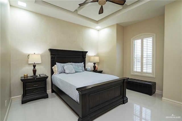 bedroom featuring a tray ceiling and ceiling fan