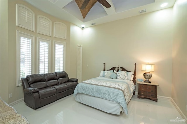 bedroom featuring a high ceiling and ceiling fan