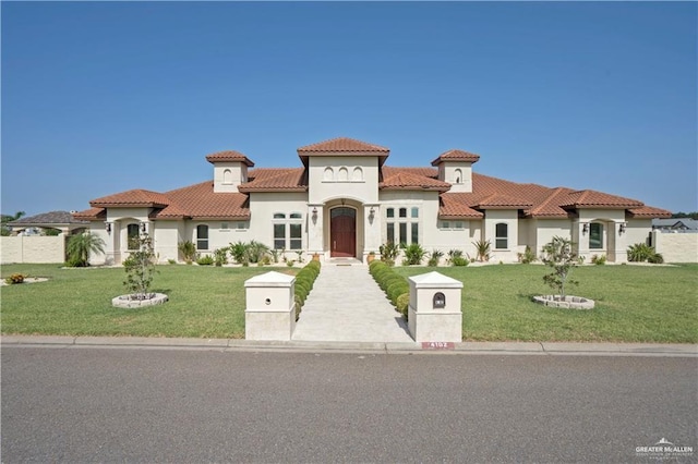 mediterranean / spanish-style home with a front lawn