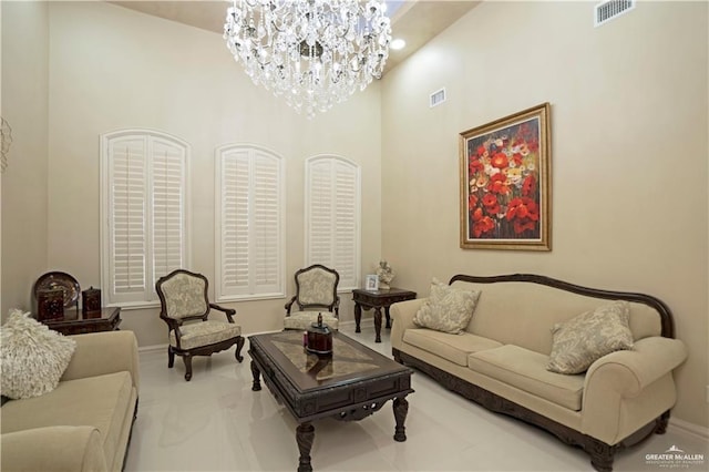 living room with a towering ceiling and an inviting chandelier