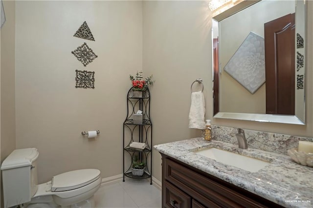 bathroom featuring tile patterned flooring, vanity, and toilet