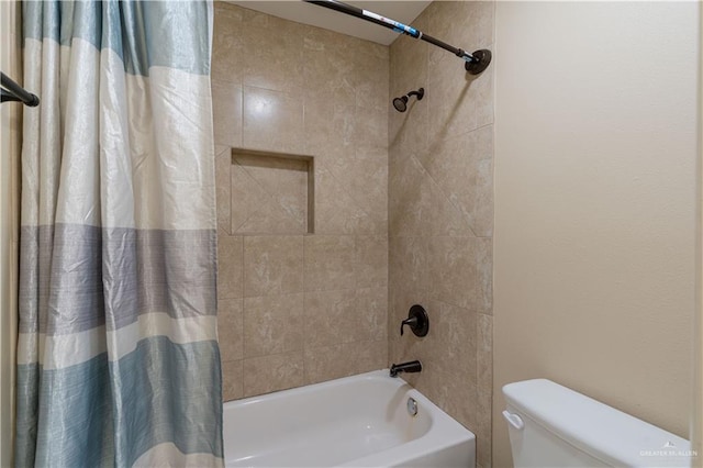 bathroom with toilet and shower / bath combo