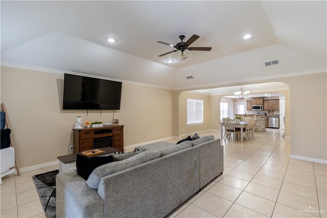 living room featuring visible vents, vaulted ceiling, arched walkways, and light tile patterned flooring