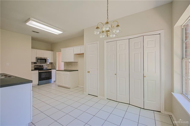 4612 Laurel Ave, Mcallen, TX 78501 - kitchen with stainless steel appliances, dark countertops, a chandelier, and white cabinets