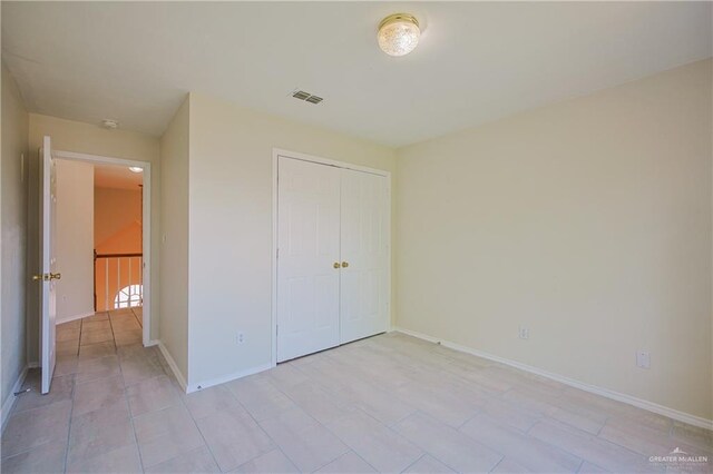 4612 Laurel Ave, Mcallen, TX 78501 - unfurnished bedroom featuring a closet, baseboards, and light tile patterned floors
