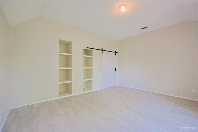 4612 Laurel Ave, Mcallen, TX 78501 - unfurnished bedroom featuring lofted ceiling, a barn door, and baseboards