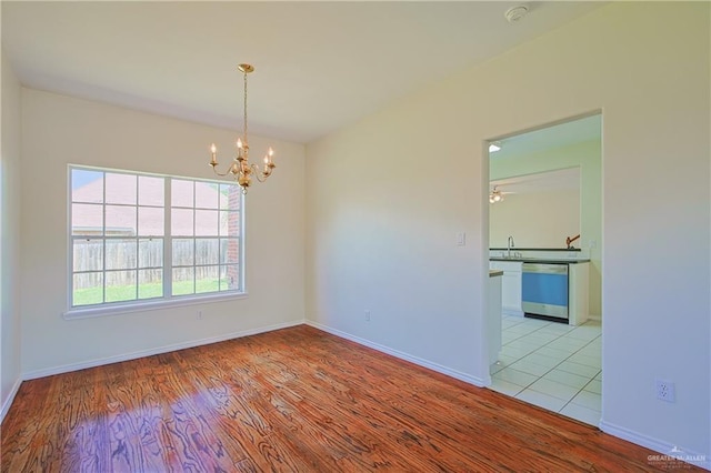 4612 Laurel Ave, Mcallen, TX 78501 - unfurnished room featuring wood finished floors, a chandelier, and baseboards
