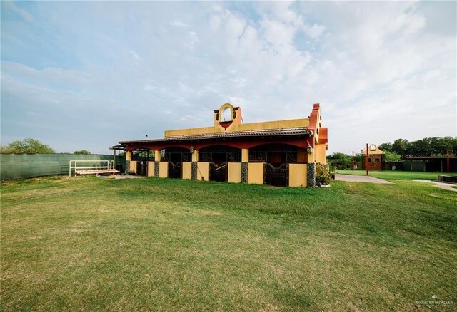 rear view of house with an exterior structure and an outbuilding