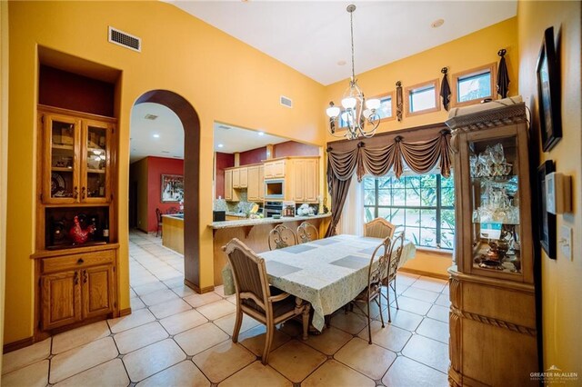 dining area featuring a notable chandelier, visible vents, and a wealth of natural light