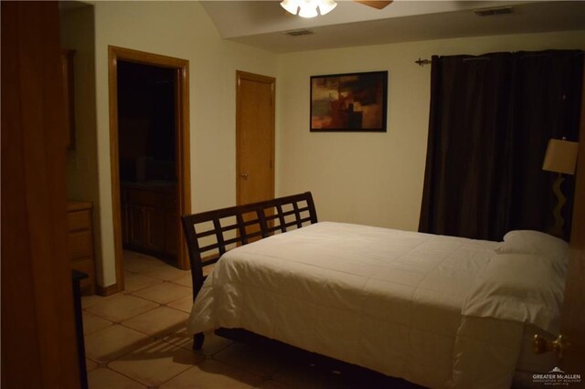 bedroom with light tile patterned floors, visible vents, and a ceiling fan